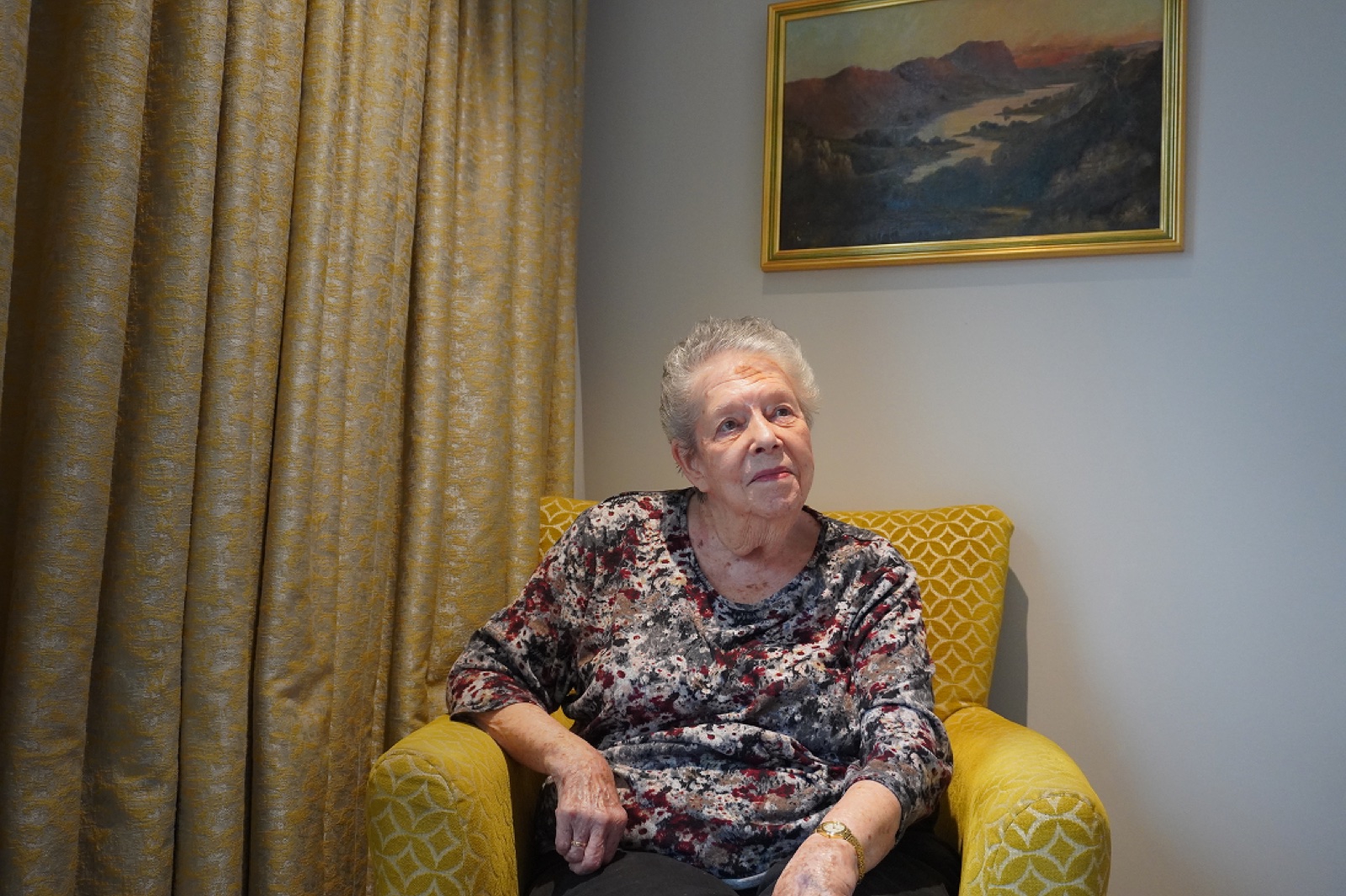 Gwen sitting in her apartment at Nightingale Hammerson